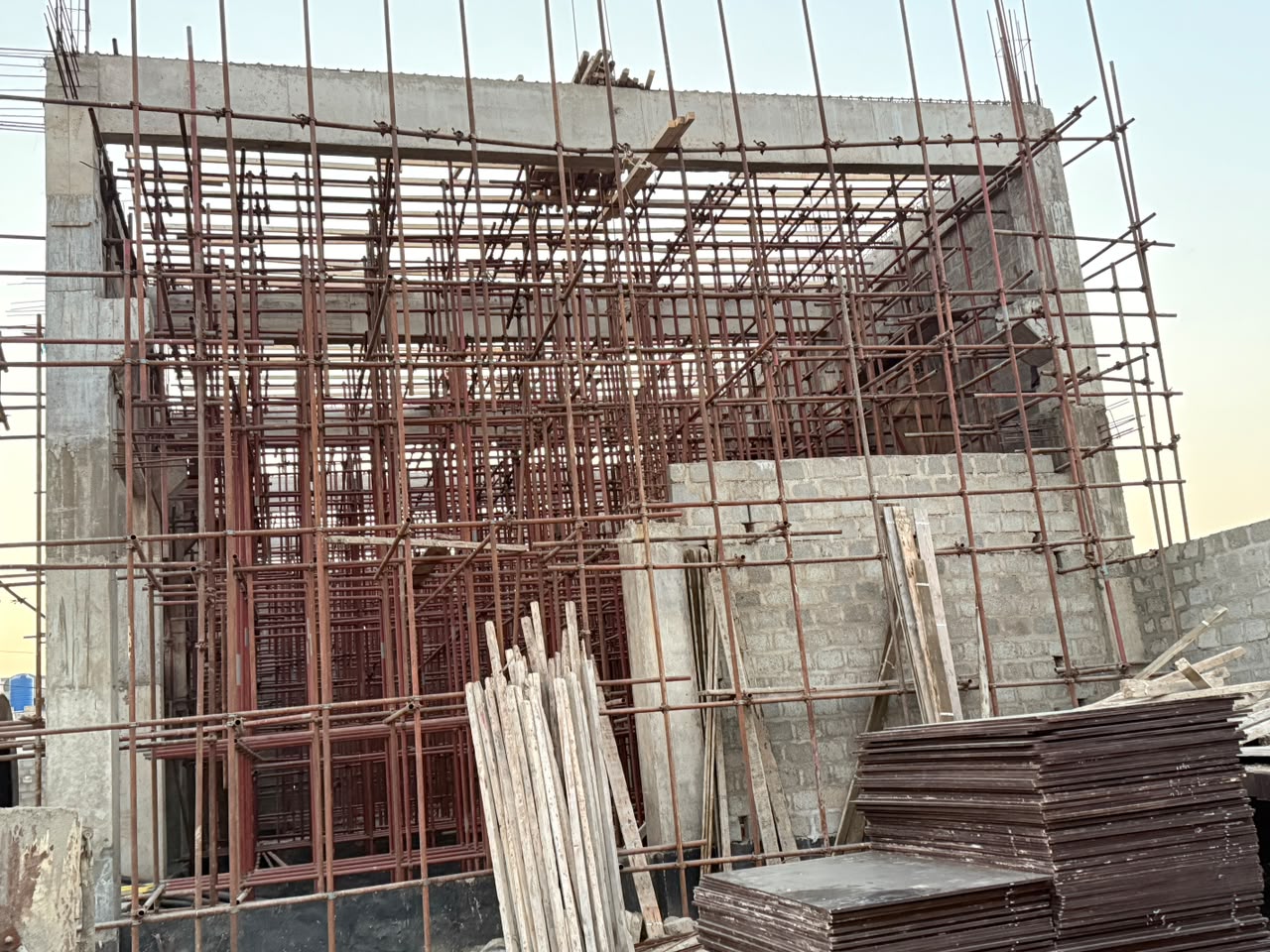 Reinforced concrete structure under construction with scaffolding
